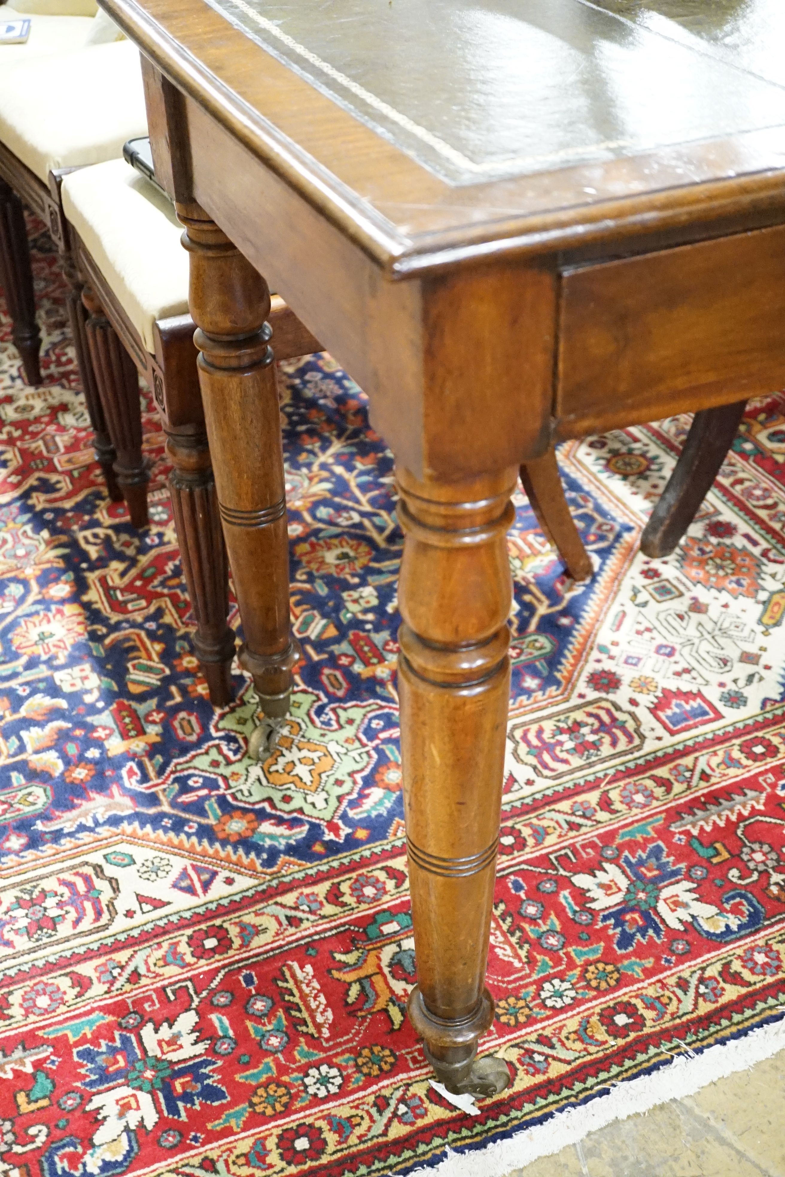 A late Victorian mahogany writing table, width 115cm, height 74cm